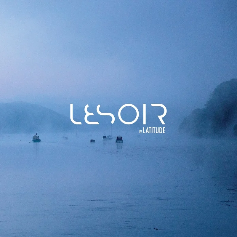Latitude cover: a misty blue lake with small boats and the white Lesoir wordmark